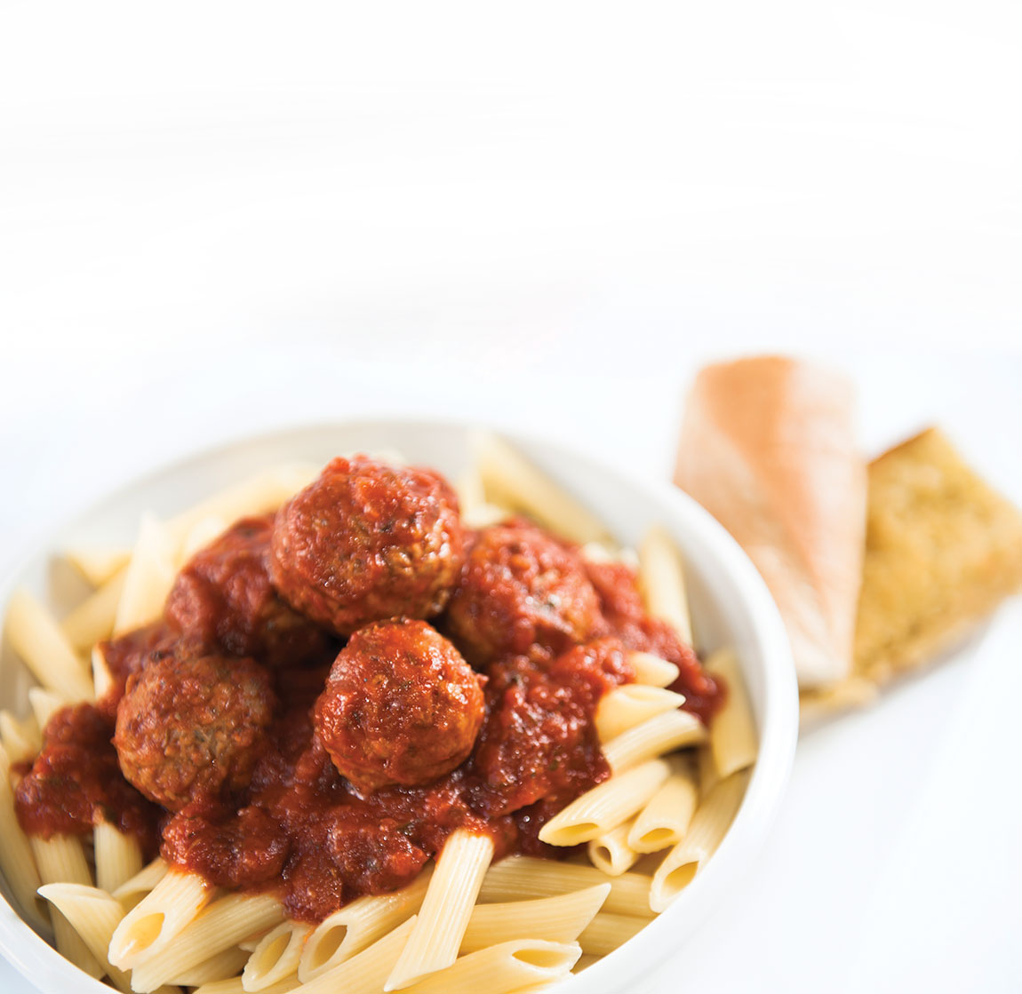 Pasta and meatballs in a bowl.